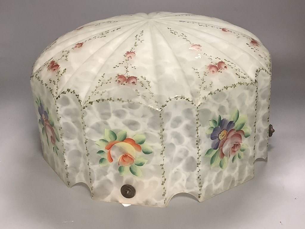 A large galss ceiling light with floral pattern